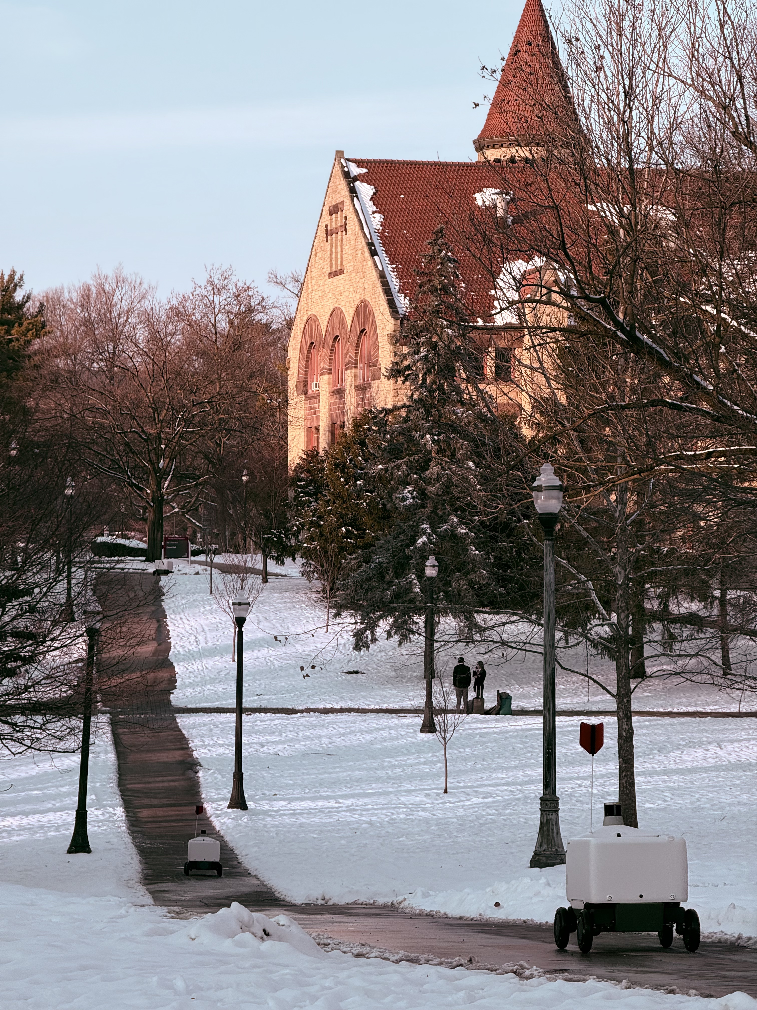 Snowy campus path with robot